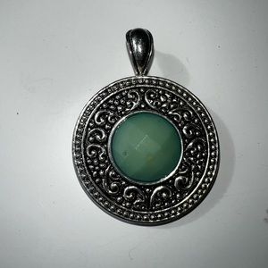 Silver necklace pendant with light green stone. It is 1 1/2 inches long